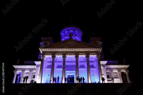 People stant in front of illuminated Helsinki St Nicholas cathed photo