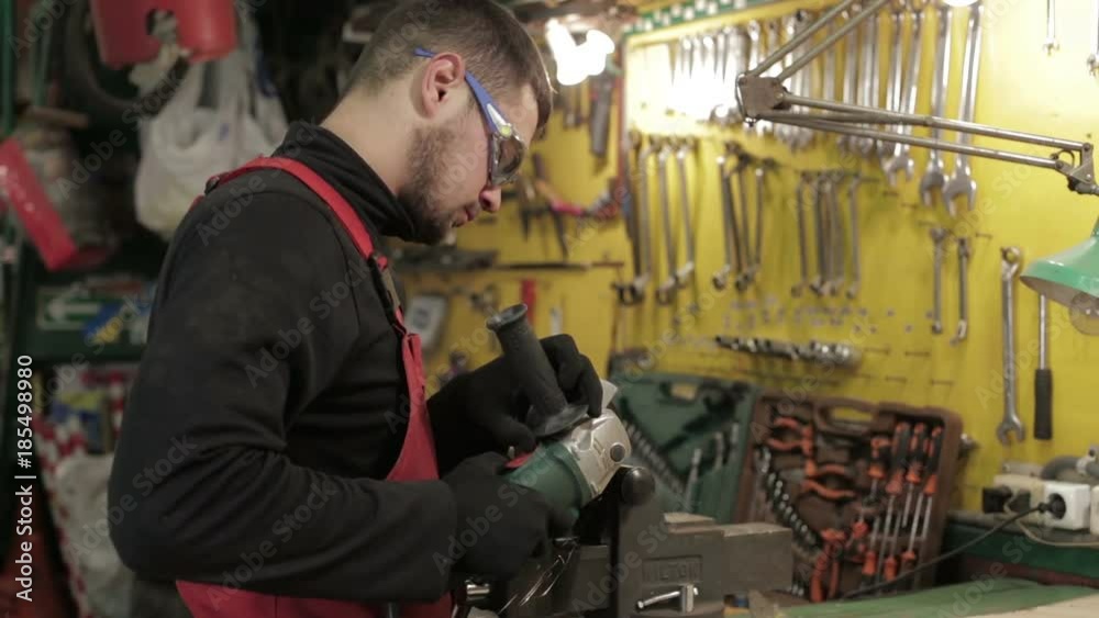 The auto-mechanic cut off the pipe with angle grinder. The auto-mechanic cut off the pipe with angle grinder.