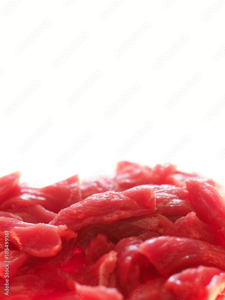 Sliced slices of raw beef isolated on white background. Pile of meat background Sliced slices of raw beef isolated on white background. Pile of meat background