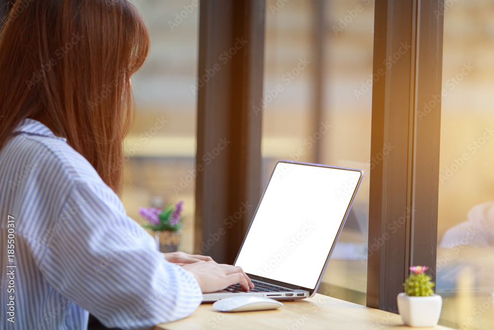 Freelancing woman using laptop computer for distance job while sitting in coffee shop. Business woman typing on laptop at workplace Woman working in home office hand keyboard. Freelancing woman using laptop computer for distance job while sitting in coffee shop. Business woman typing on laptop at workplace Woman working in home office hand keyboard.