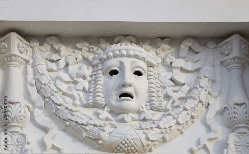 Plaster mask on the wall of the theater.