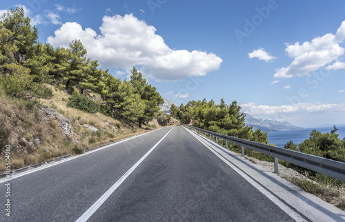 Asphalt road to the sea. Asphalt highway in a sunny day. © Denis Rozhnovsky