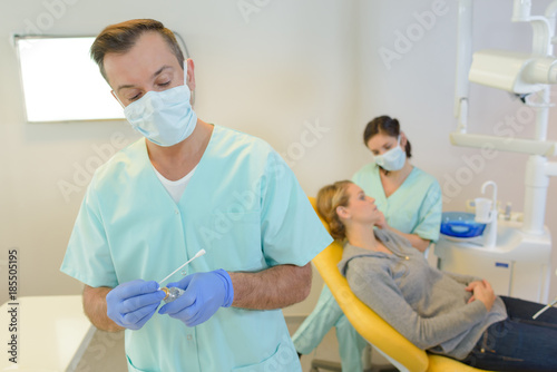dentist curing a woman patient in the dental office