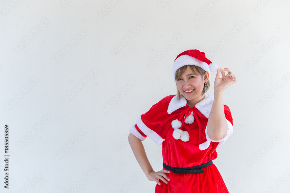 Obraz premium Beautiful young asian woman in Santa Claus clothes on white background,Thailand people,Sent happiness for children,Merry christmas,Welcome to winter,Happy woman concept