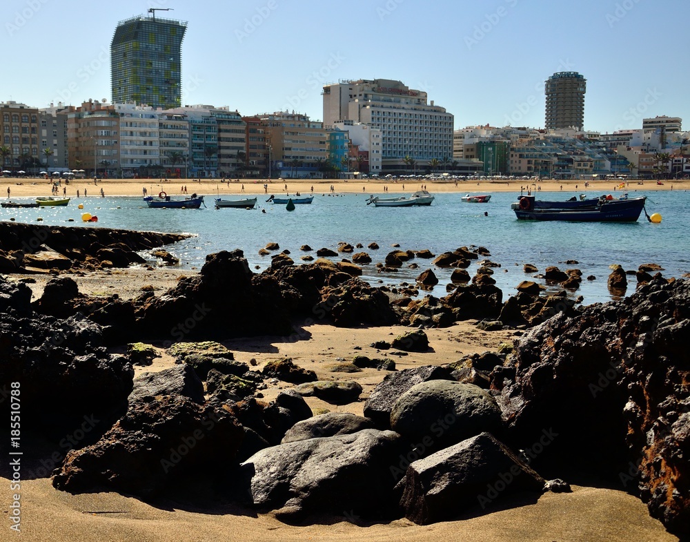 Cove of rocks and sand at low tide, Las Canteras beach, Las Palmas city, Canary islands
