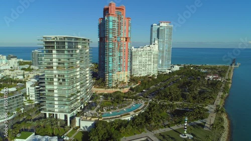 Aerial establishing drone video Miami Beach waterfront condominiums flyover tilt down