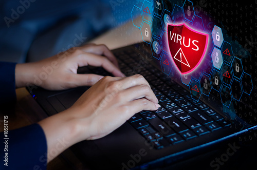 Press enter button on the keyboard computer Protective shield virus red Exclamation Warning Caution Computer in dark with word virus photo