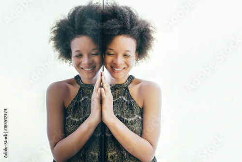 Portrait of smiling woman and her reflection in mirror 