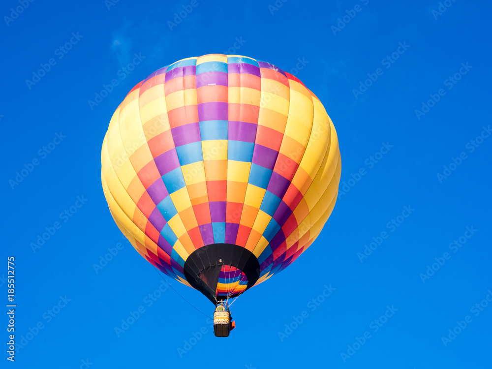 Colorful hot air balloon flying in the bright blue sky during Winthrop Balloon Festival in Washington state Colorful hot air balloon flying in the bright blue sky during Winthrop Balloon Festival in Washington state