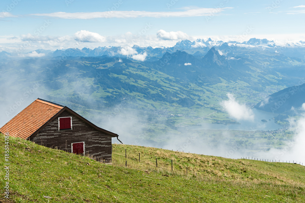 Swiss alps. View from mount Rigi in Central Switzerland. House in the foreground, lake Lauerz in the background.