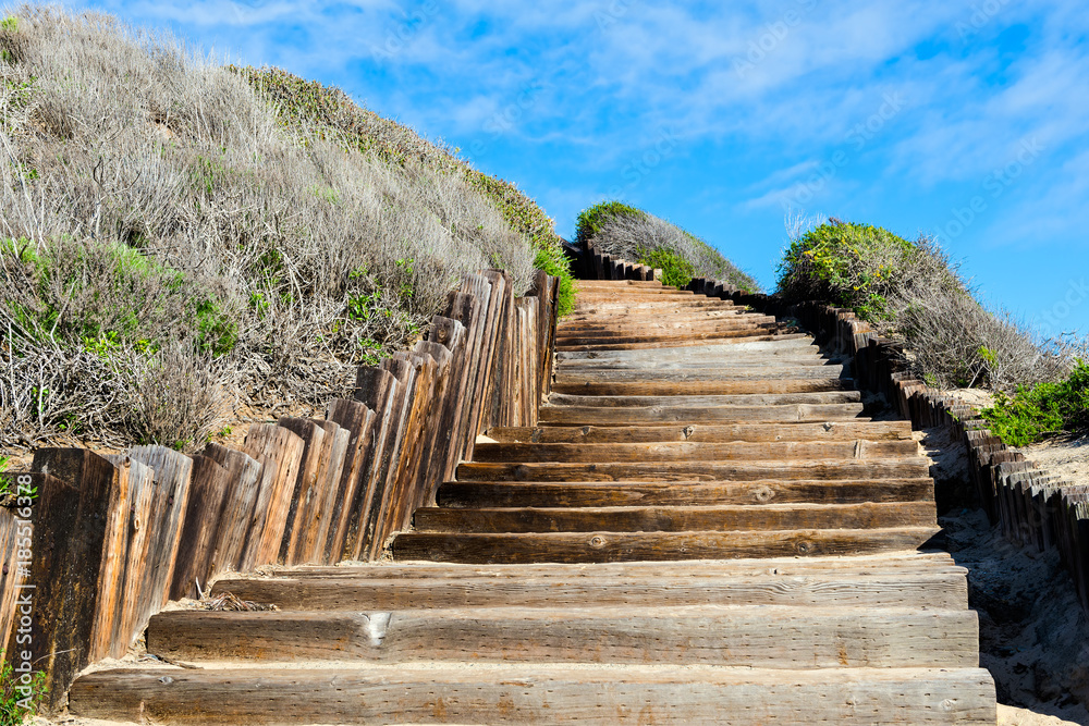 Fototapeta premium Old wooden stairways to the see beach, but it looks like a stairways to sky or stairways to haven