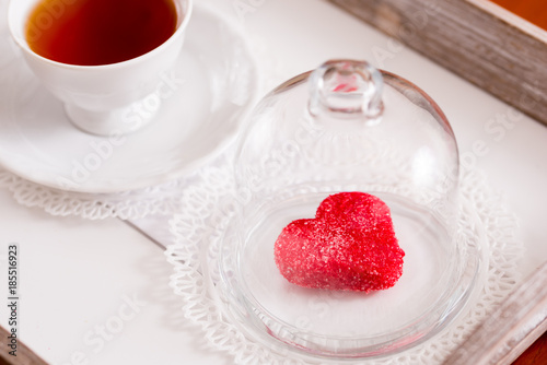 tea cup with heart shaped biscuits. Sugar red biscuits. photo