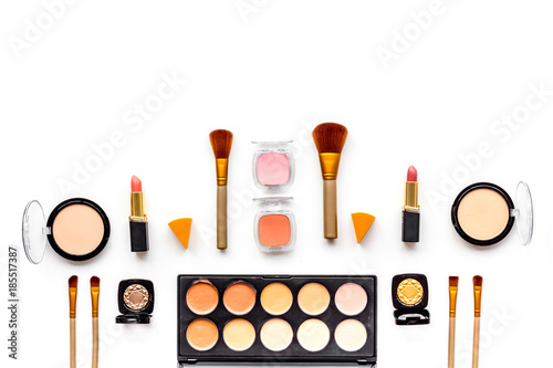 Professional bulk cosmetics pattern. Eyeshadows, rouge, brushes on white background top view copyspace