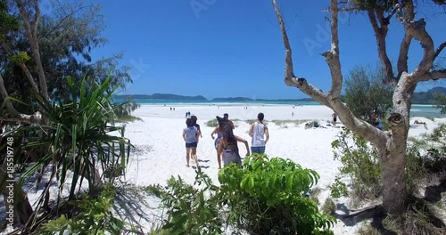 WHITSUNDAY ISLANDS – FEBRUARY 2016 : Aerial shot of people running towards ocean on Whitehaven Beach on a beautiful day  photo