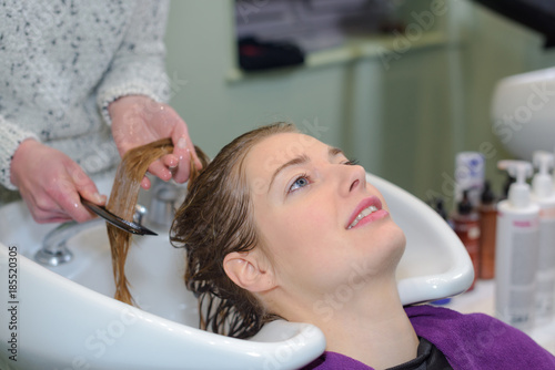 female having hairwashed at a salon