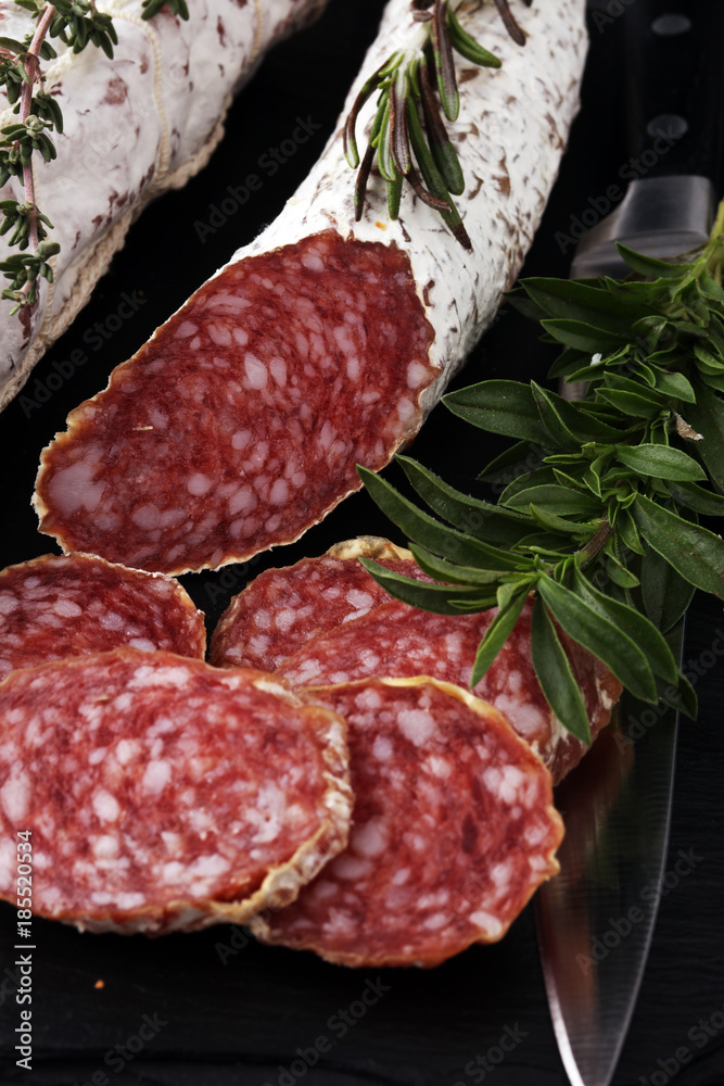 Marble cutting board with sliced salami on it Marble cutting board with sliced salami on it