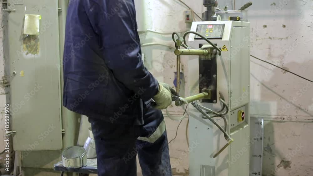 Worker in manufacturing plant working with steel, production of industrial ventilation systems Worker in manufacturing plant working with steel, production of industrial ventilation systems