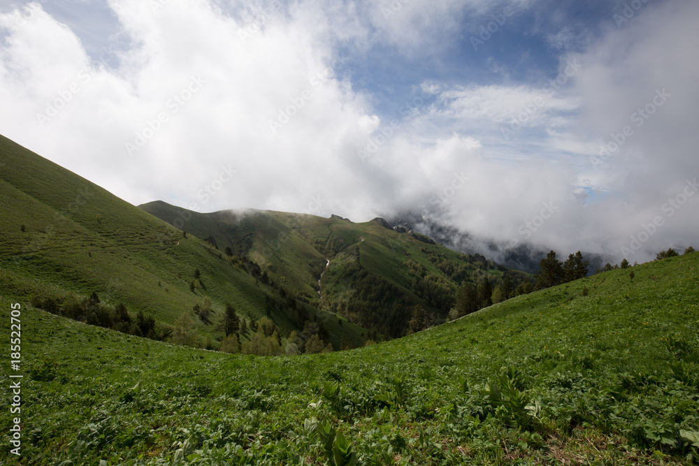 The formation and movement of clouds over the summer slopes of Adygea Bolshoy Thach and the Caucasus Mountains The formation and movement of clouds over the summer slopes of Adygea Bolshoy Thach and the Caucasus Mountains