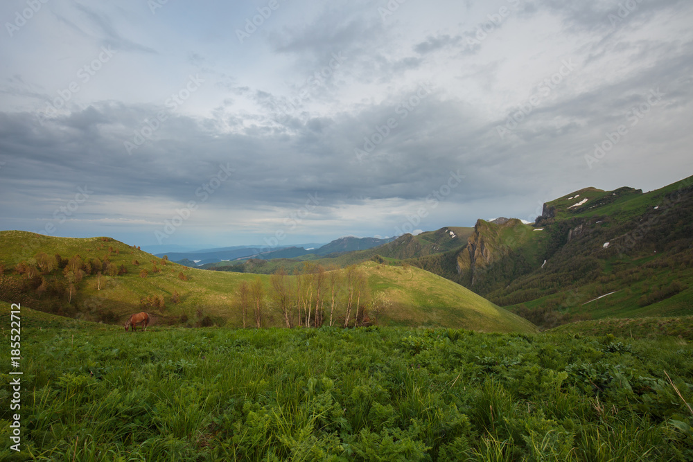 Fototapeta premium The formation and movement of clouds over the summer slopes of Adygea Bolshoy Thach and the Caucasus Mountains