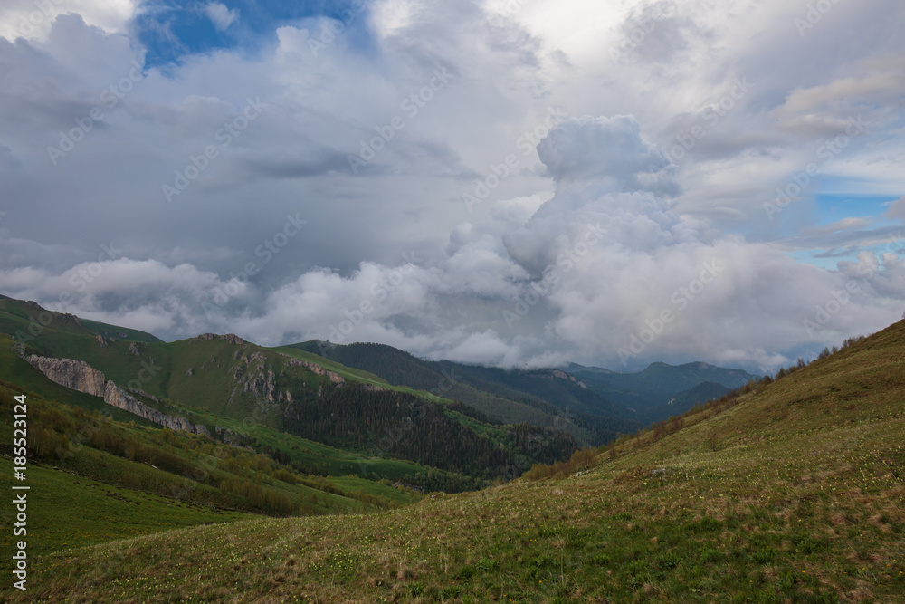 The formation and movement of clouds over the summer slopes of Adygea Bolshoy Thach and the Caucasus Mountains