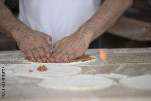 Man Preparing Lahmacun Dough With Hands on the Kitchen Desk