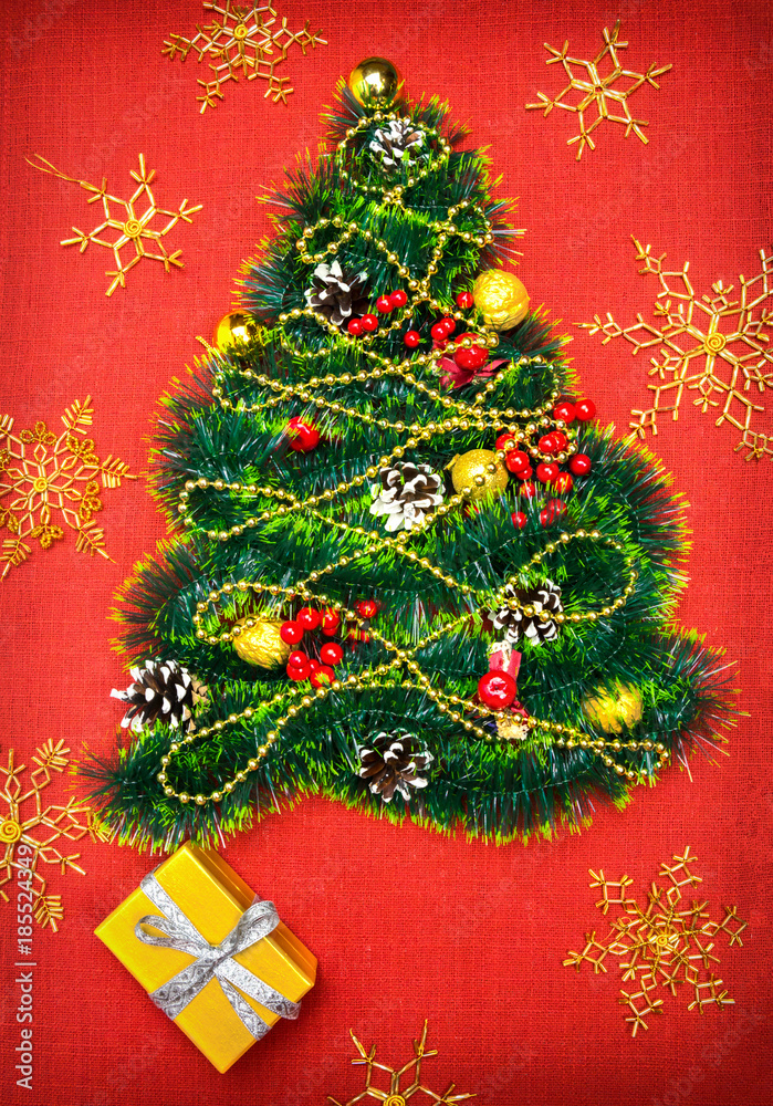 a small Christmas tree of tinsel, nuts, ribbons and ornaments. Gift for a Christmas tree, a vintage watch. 2018,