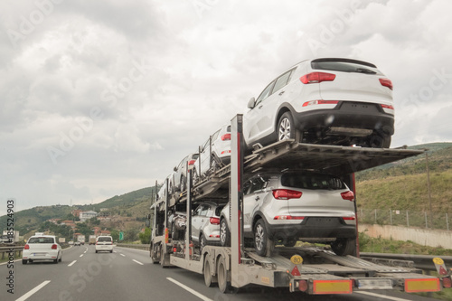 A Truck Making Transportation and Carries Cars For Selling on the Road © celaler