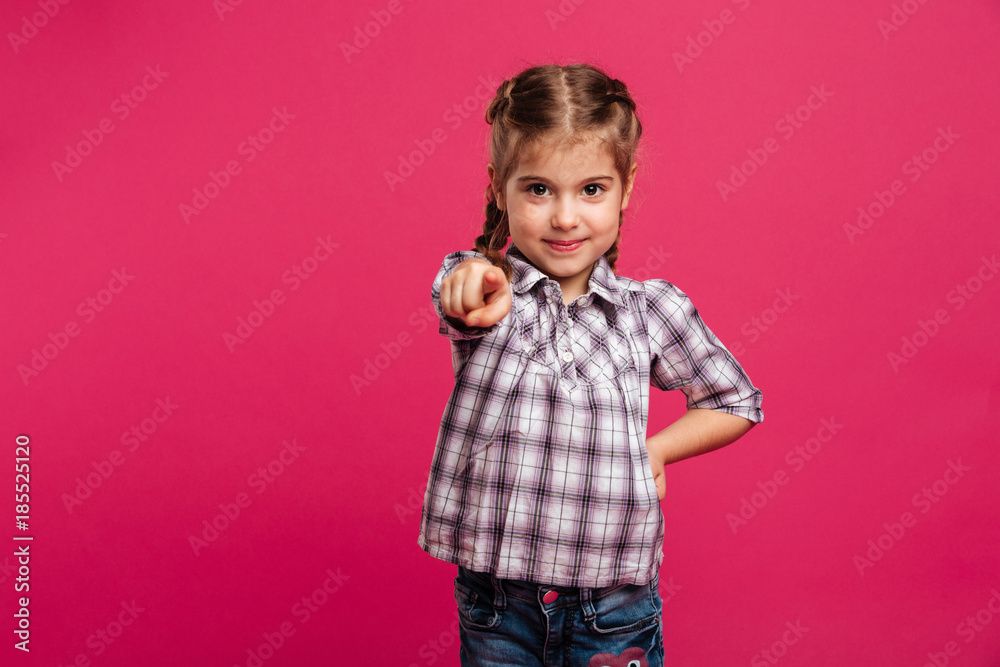 Cheerful little girl child pointing to you. Cheerful little girl child pointing to you.