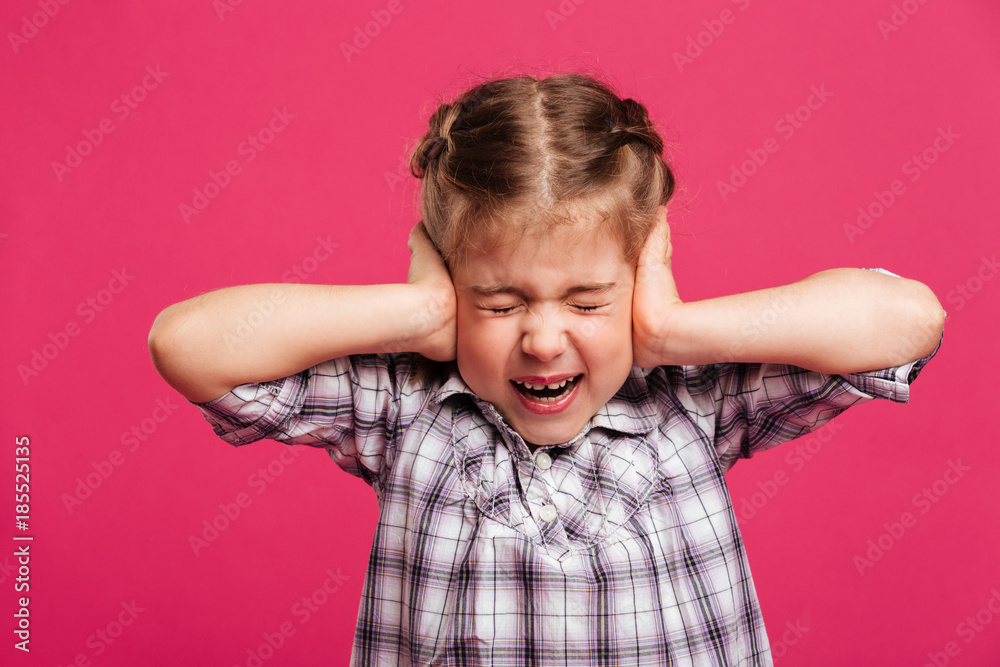 Screaming emotional little girl child holding head with hands. Screaming emotional little girl child holding head with hands.