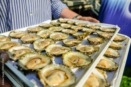 A man carries a tray of 30 Galway oysters at the International Oyster Festival. photo