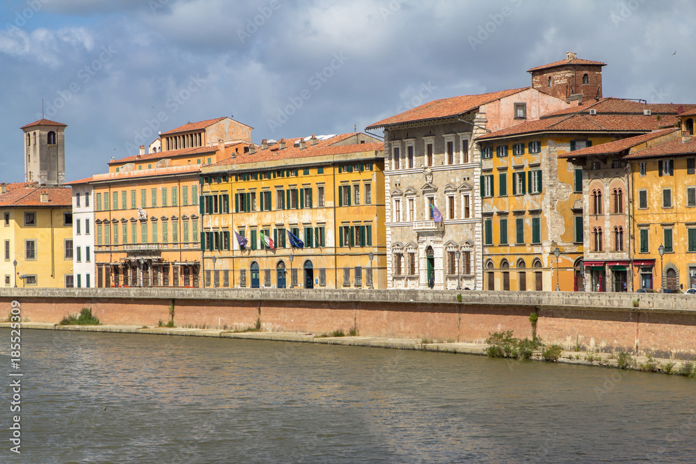 Bright italian houses on the Arno river in Pisa, Tuscany, Italy.