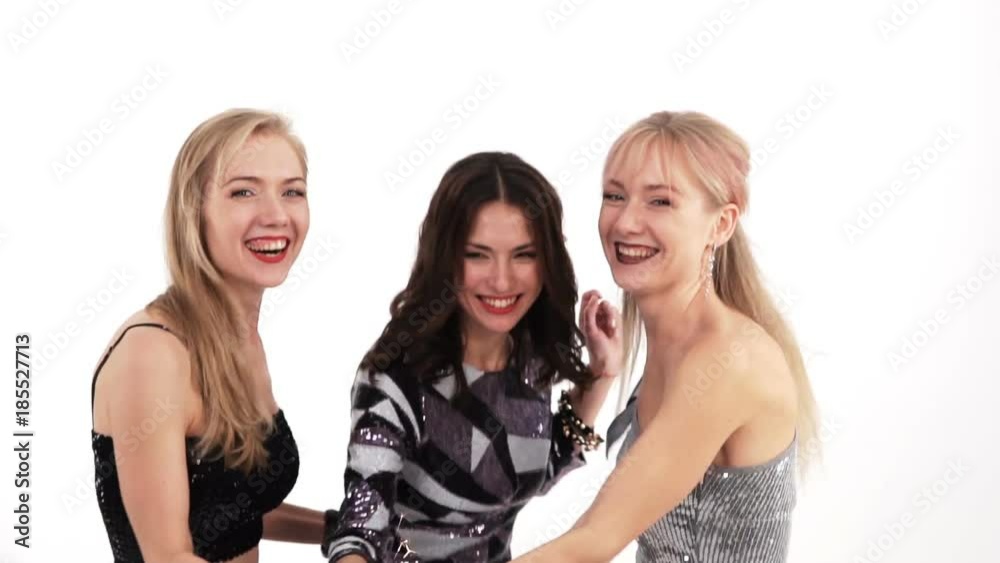 3 beautiful cheerful girls with bengal lights dancing in the studio on a white background 3 beautiful cheerful girls with bengal lights dancing in the studio on a white background