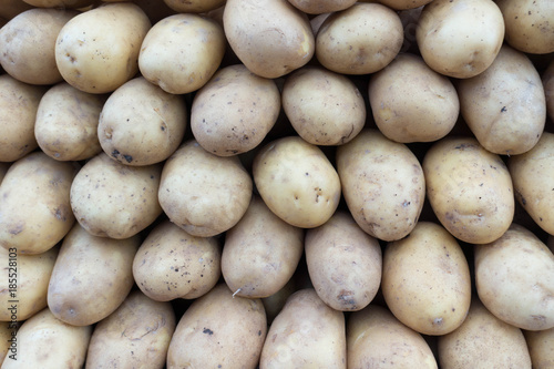Fresh Organic Potatoes Stack on Market Stall