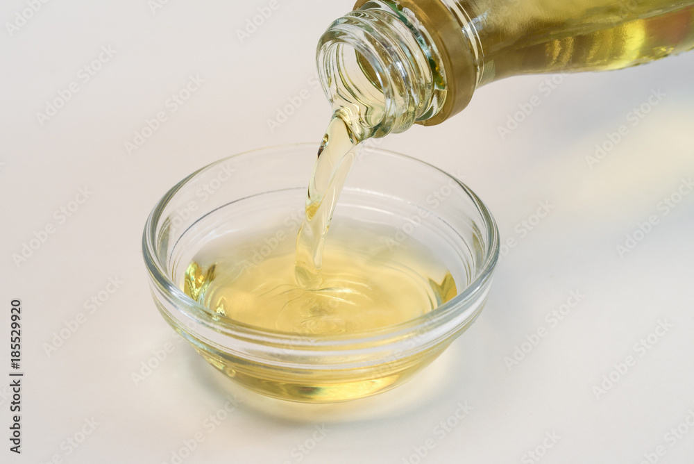 Pouring Bottled Lime Juice into an Ingredient Bowl Pouring Bottled Lime Juice into an Ingredient Bowl