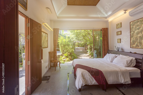 Luxury villa bed room interior. Open space, garden terrace © Annatamila