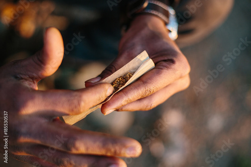 Hands holding hashish and tobacco. Hash which is a drug made from herbal cannabis marijuana
