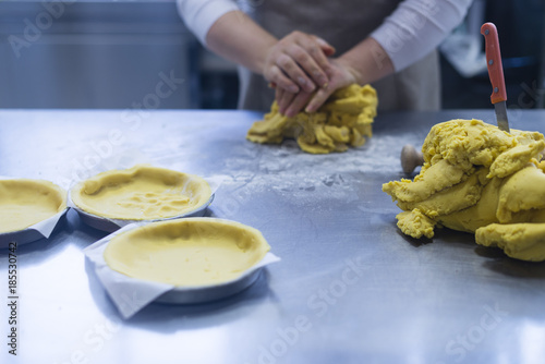 Working the dough and making cakes in the kitchen photo