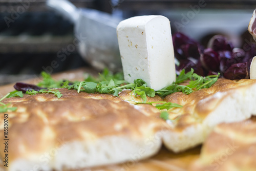 Preparing focaccia pizza with arugula, ham, cheese and radicchio photo