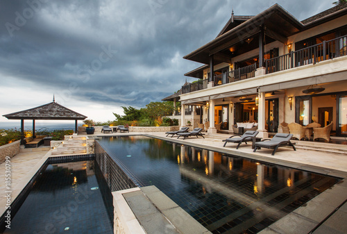 Luxury tropical villa with big swimming pool interior outside © Annatamila