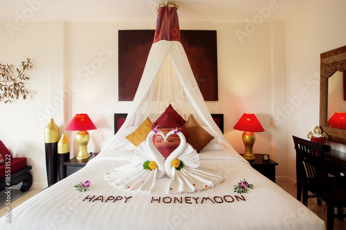 Luxury hotel bedroom interior with honeymoon decoration photo
