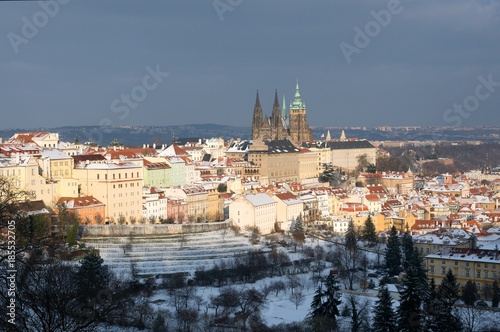 Prague castle and snowy roofs of Mala Strana from Seminarska Garden in Prague, Czech republic