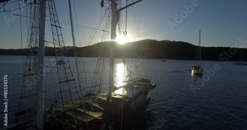 WHITSUNDAY ISLANDS – FEBRUARY 2016 : Aerial shot of Solway Lass ship / sailboat at beautiful sunset with boats and landscape in view photo