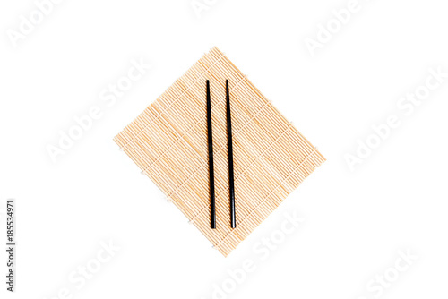 Bamboo mat wooden chopsticks isolated on white background