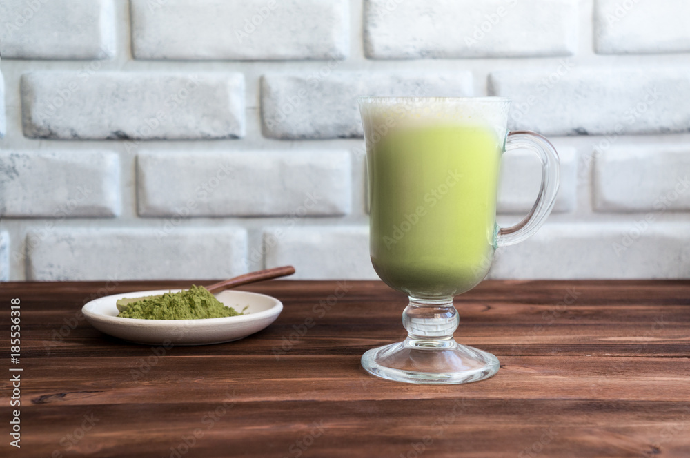 Matcha latte on wooden table. Creamy drink with milk and japanese green tea powder. Matcha latte on wooden table. Creamy drink with milk and japanese green tea powder.