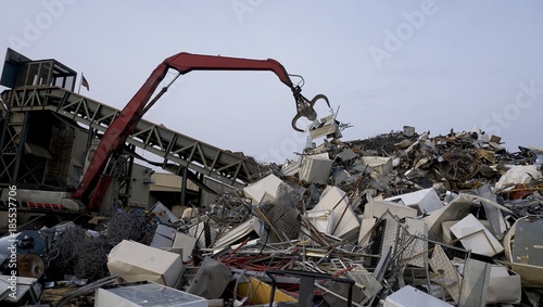 scrapyard recycling center creates beautiful manmade landscapes from waste metal using cranes with claws 