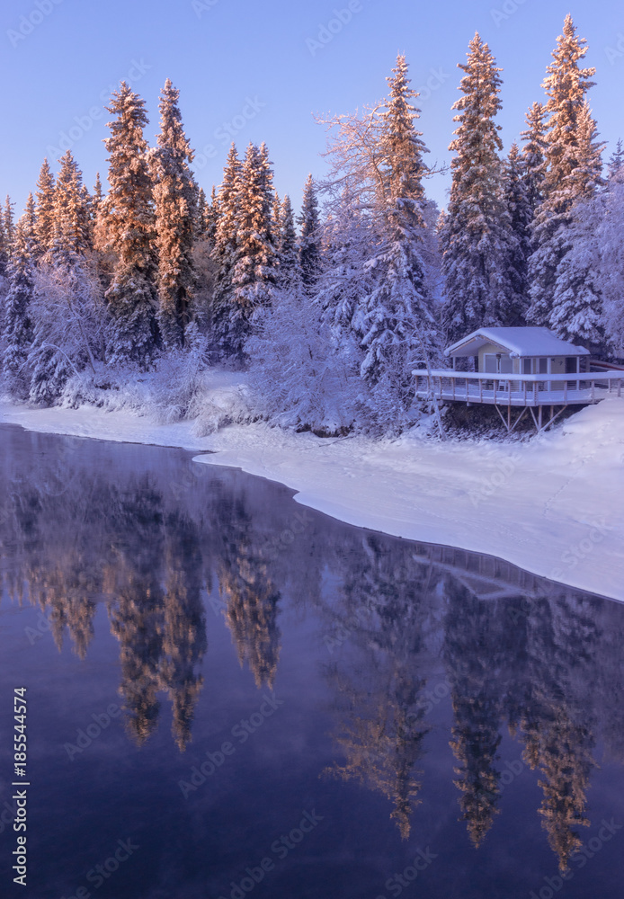 Cabin on river in snowy Alaska Cabin on river in snowy Alaska