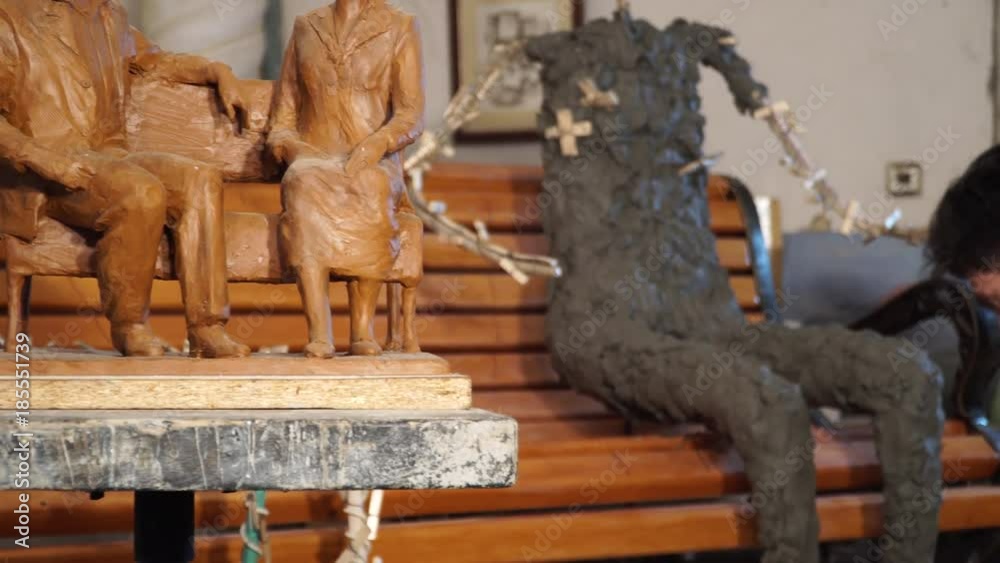 the sculptor is working on the creation of a monument - the process of making a monument in full growth from clay – 4k video the sculptor is working on the creation of a monument - the process of making a monument in full growth from clay – 4k video