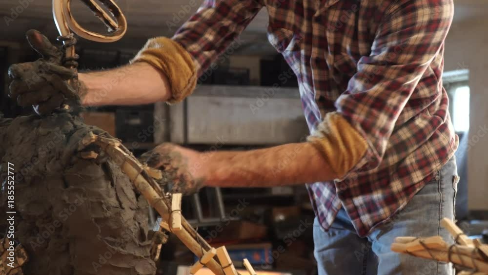 the sculptor is working on the creation of a monument - the process of making a monument in full growth from clay – 4k video the sculptor is working on the creation of a monument - the process of making a monument in full growth from clay – 4k video