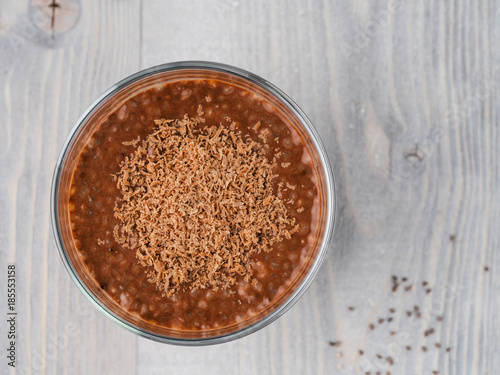 Chocolate chia pudding in glass on gray table