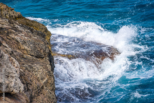 Waves hitting the rocky sea coast.